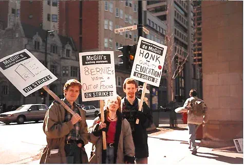 A group of three picketers posing for the camera.
