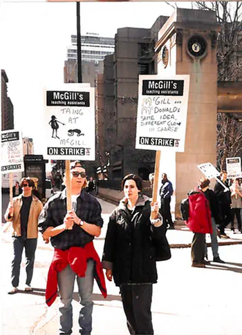 Pickets with signs. One reads "TAing at McGill" with a stick figure groveling on the ground in front of their employer. The other reads "McGill and McDonalds: Same idea, different clown in charge".